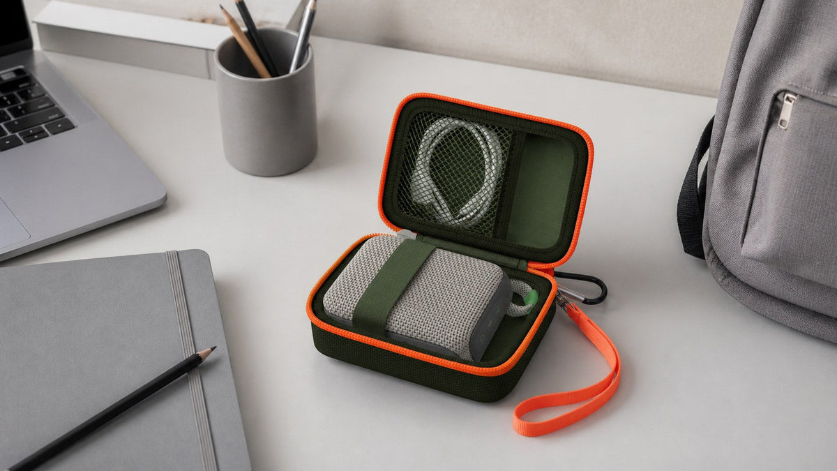 ALKOO olive and orange for JBL Go speaker case naturally photographed in a gray-white hybrid work desk scene