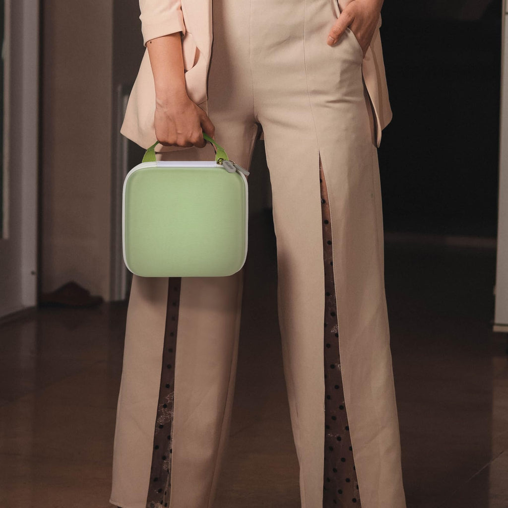 Person carrying the light green for NIIMBOT label maker case by its top handle