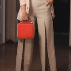Person carrying the red for NIIMBOT label maker case by its top handle
