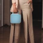 Person carrying the light blue for NIIMBOT label maker case by its top handle