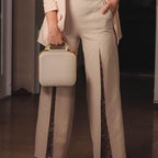 Person carrying the beige for NIIMBOT label maker case by its top handle