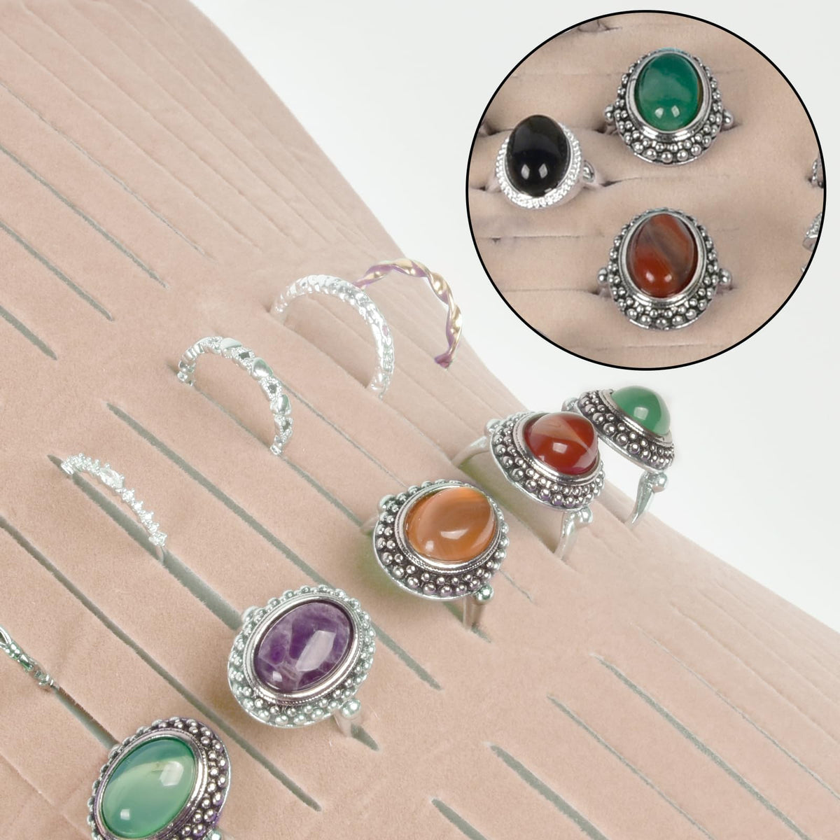 Rings and earrings displayed in the pink organizer's parallel jewelry slots
