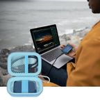 Open light blue SSD organizer beside a for Crucial portable drive connected to a laptop
