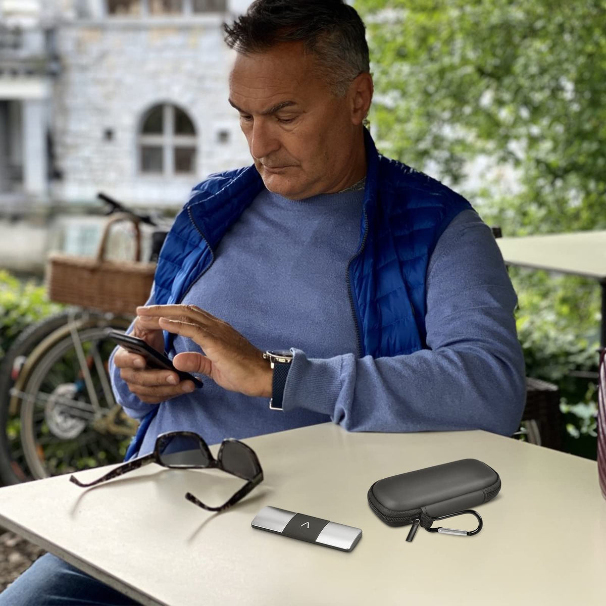 Man using a for KardiaMobile device beside the open black travel case