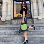 Person carrying the bright green for NIIMBOT label maker case by its top handle