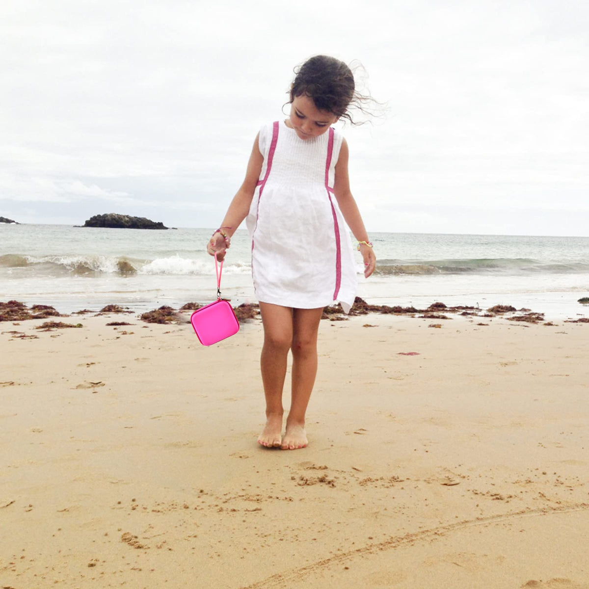 Magenta kids instant print camera case carried by a child outdoors