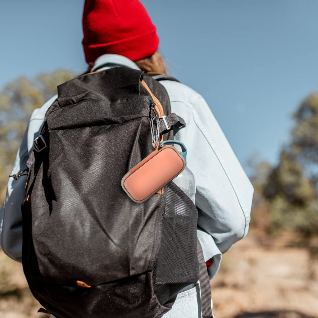 Peach for KardiaMobile case clipped to a hiking backpack