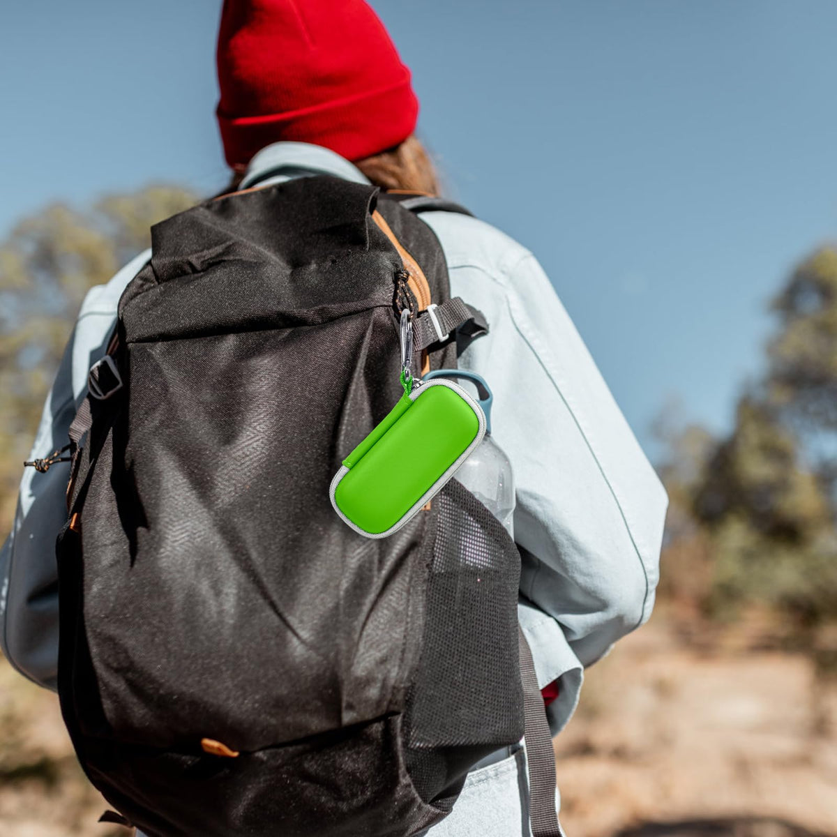 Green for KardiaMobile case clipped to a hiking backpack