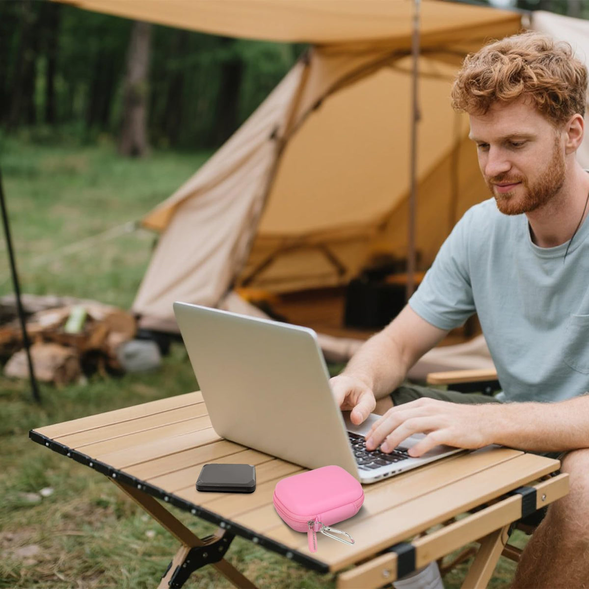 Open pink SSD organizer beside a for Crucial portable drive connected to a laptop