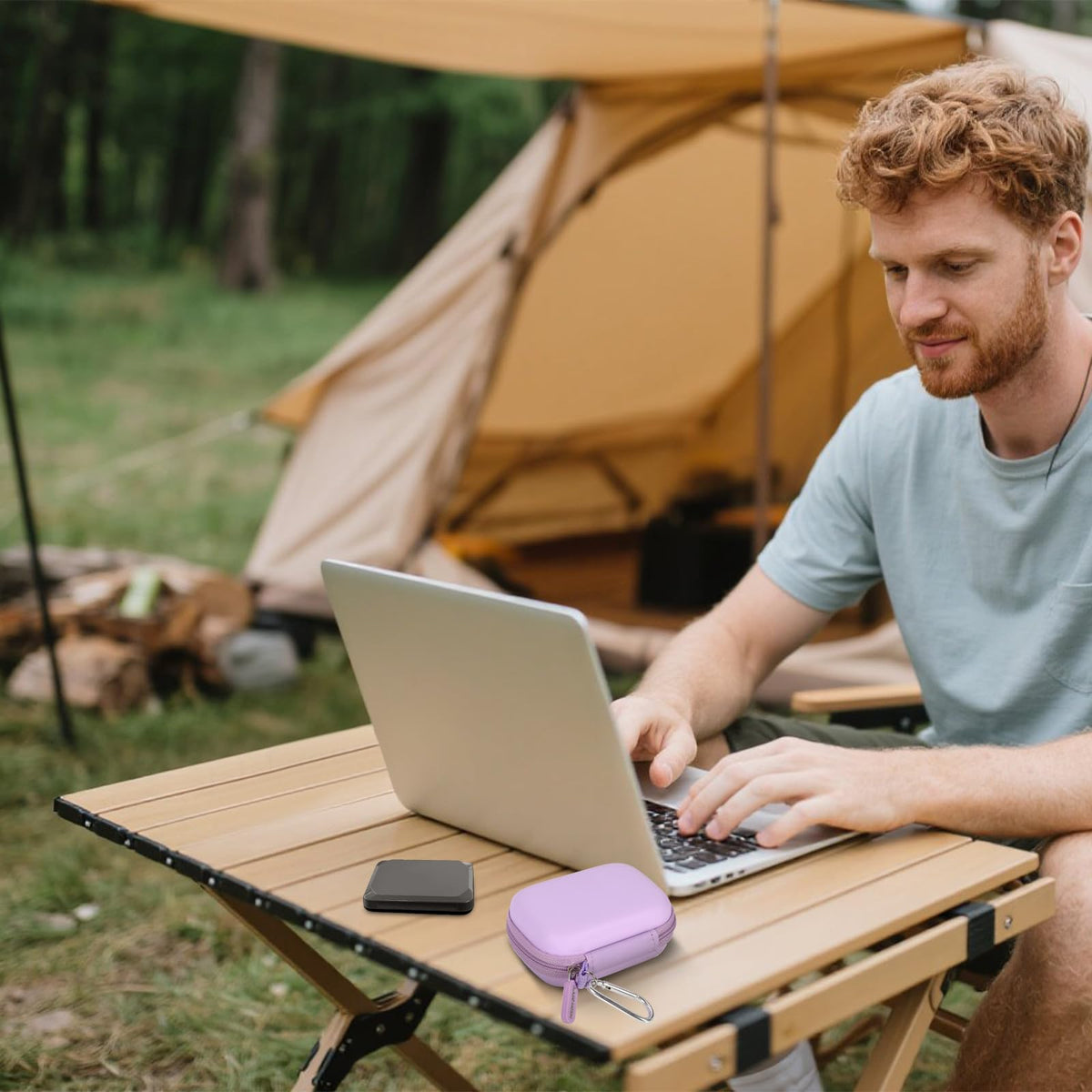 Lavender SSD case beside a portable drive during outdoor laptop use