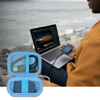Open blue SSD organizer beside a for Crucial portable drive connected to a laptop