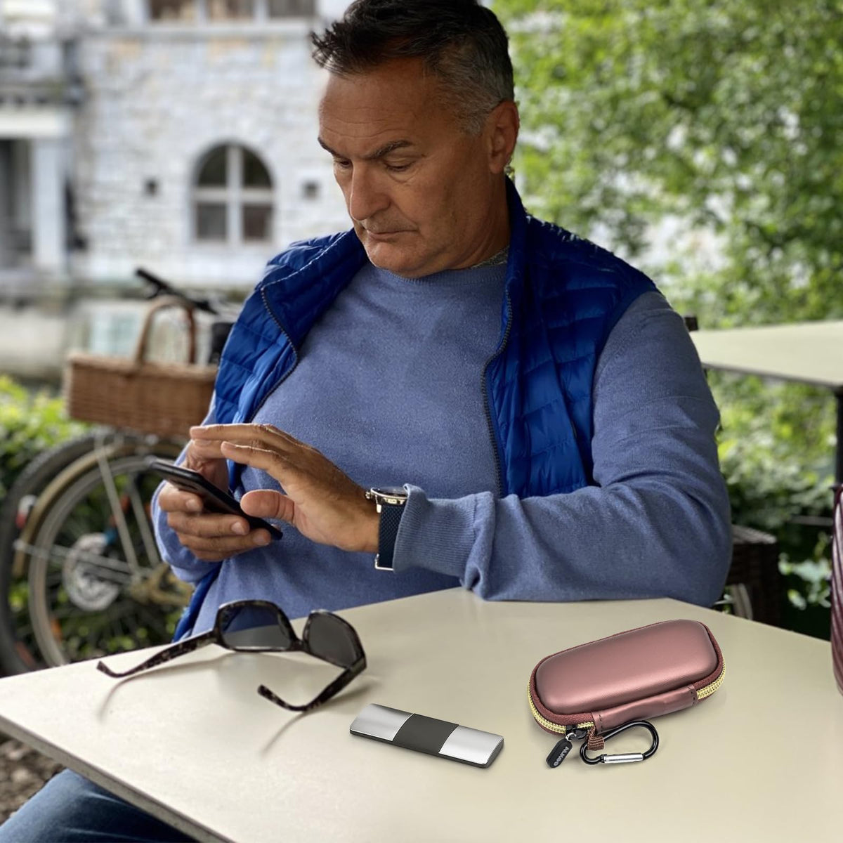 Man using a for KardiaMobile device beside the open rose gold travel case