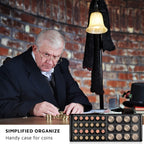 Coin collector organizing coins in the open green 300-pocket album