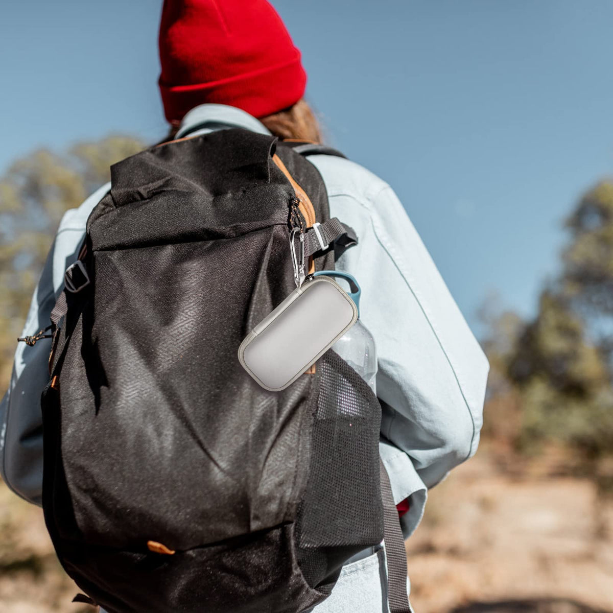 White for KardiaMobile case clipped to a hiking backpack