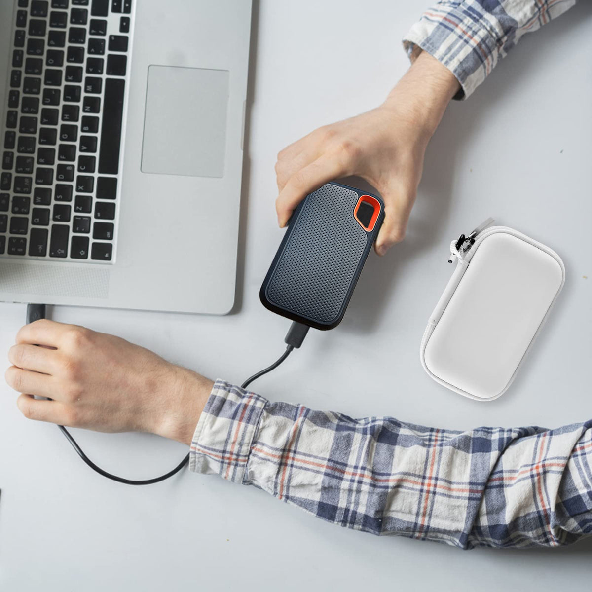 for SanDisk portable SSD and white case beside a laptop during use