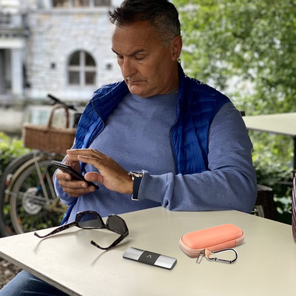 Man using a for KardiaMobile device beside the open peach travel case