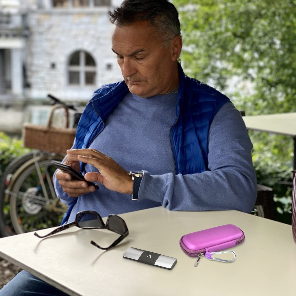 Man using a for KardiaMobile device beside the open purple travel case