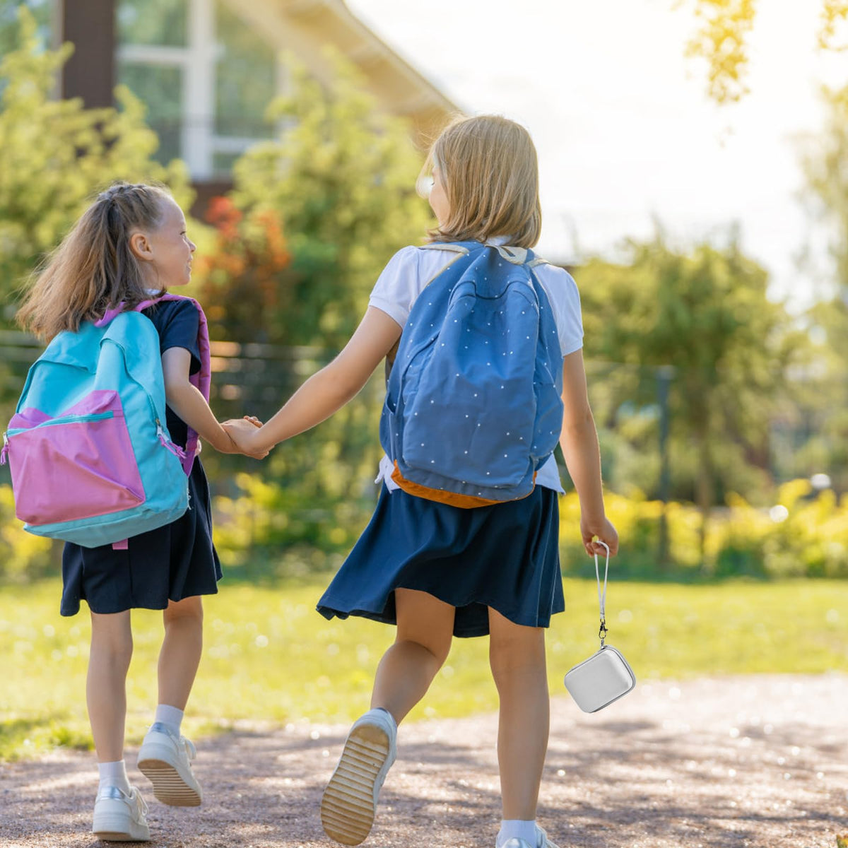 White protective digital camera case shown carried by children on an outdoor walk