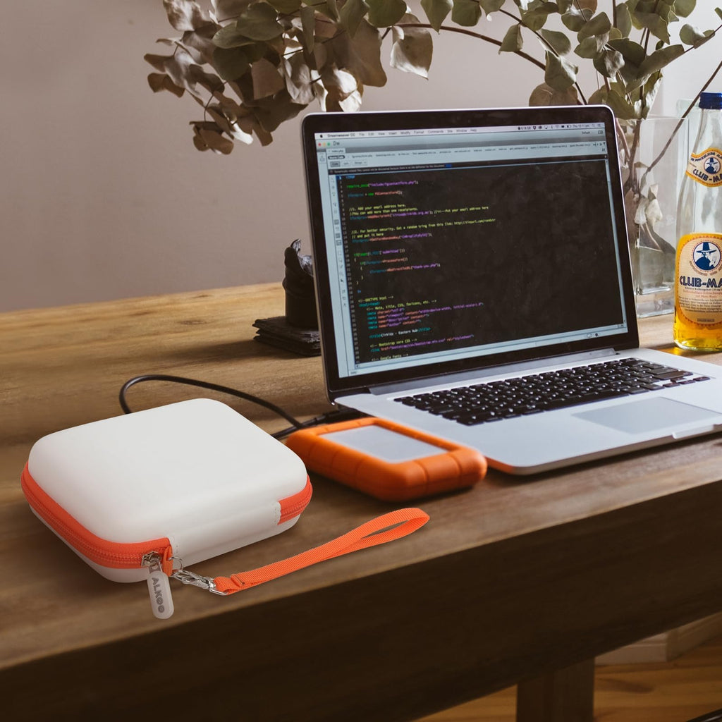 Gray and orange hard drive case beside a for LaCie Rugged Mini drive connected to a laptop