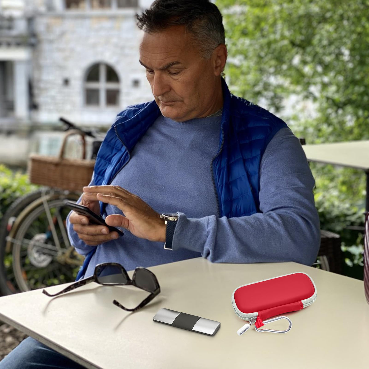 Man using a for KardiaMobile device beside the open red travel case
