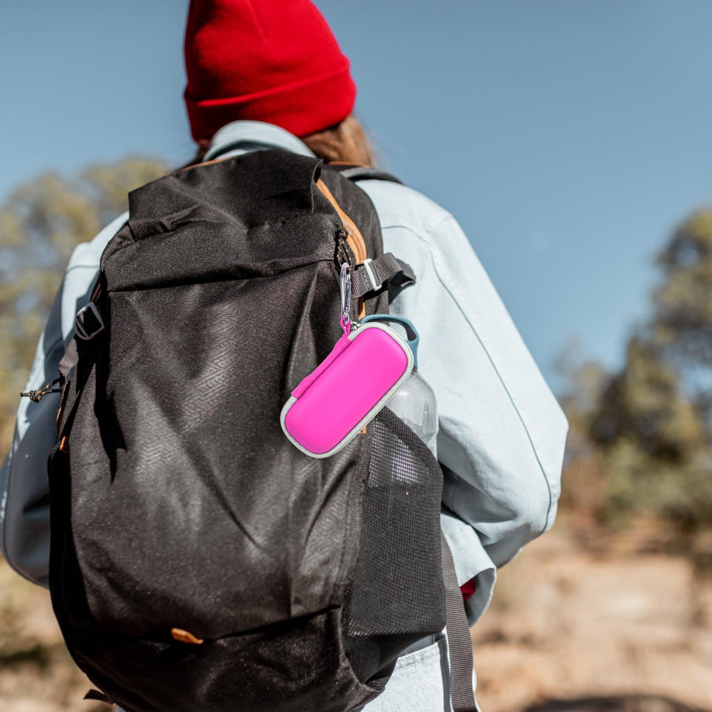 Pink for KardiaMobile case clipped to a hiking backpack