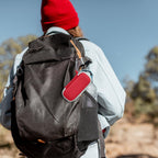 Red for KardiaMobile case clipped to a hiking backpack