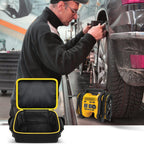 Open black and yellow air compressor bag beside a for DEWALT tire inflator at a vehicle