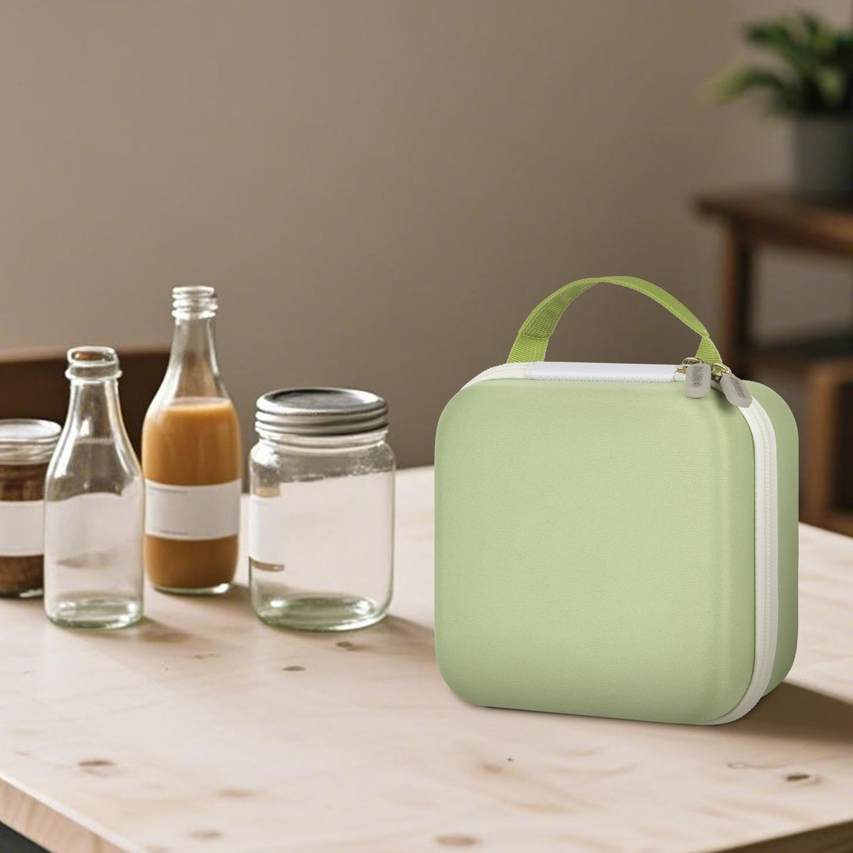 Closed light green for NIIMBOT label maker case beside bottles and jars