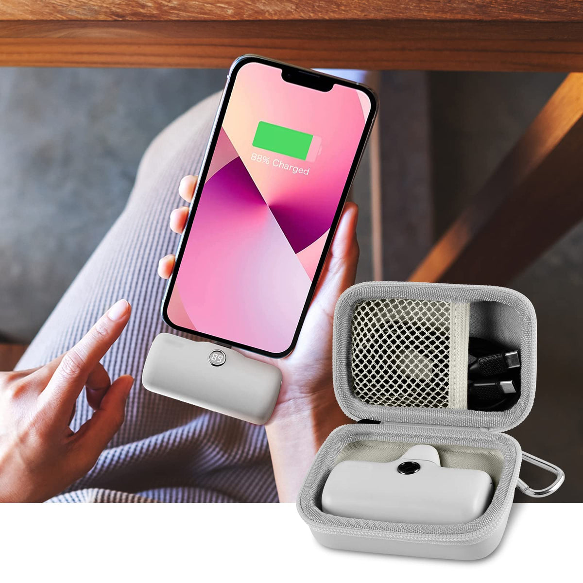 Open gray case organizing a mini power bank and cable beside a charging phone