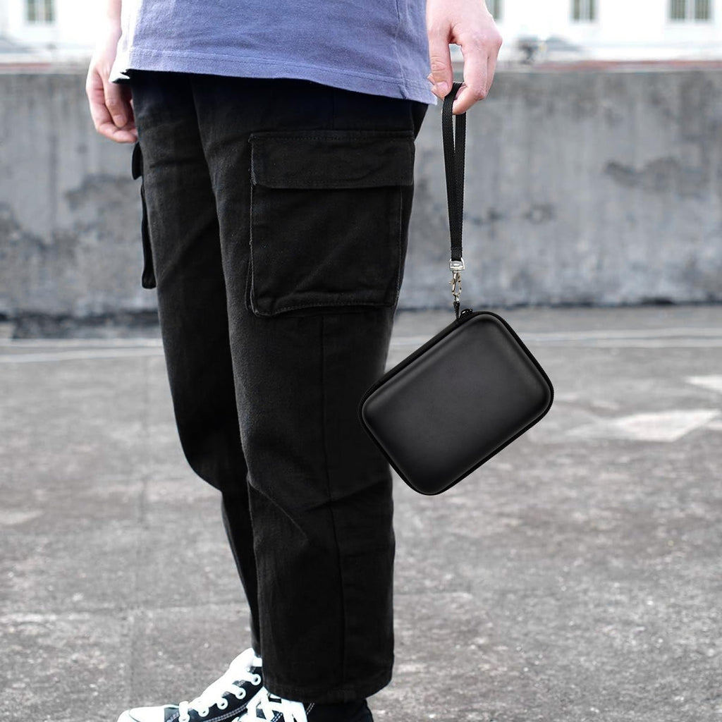 Black retro handheld console carrying case for RG40XX V carried by the wrist strap outdoors