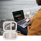 Open ivory SSD organizer beside a for Crucial portable drive connected to a laptop
