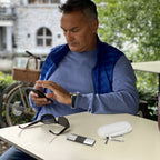 Man using a for KardiaMobile device beside the open white travel case