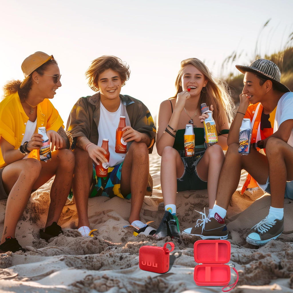 Friends using a for JBL Go speaker with the open red travel case at the beach