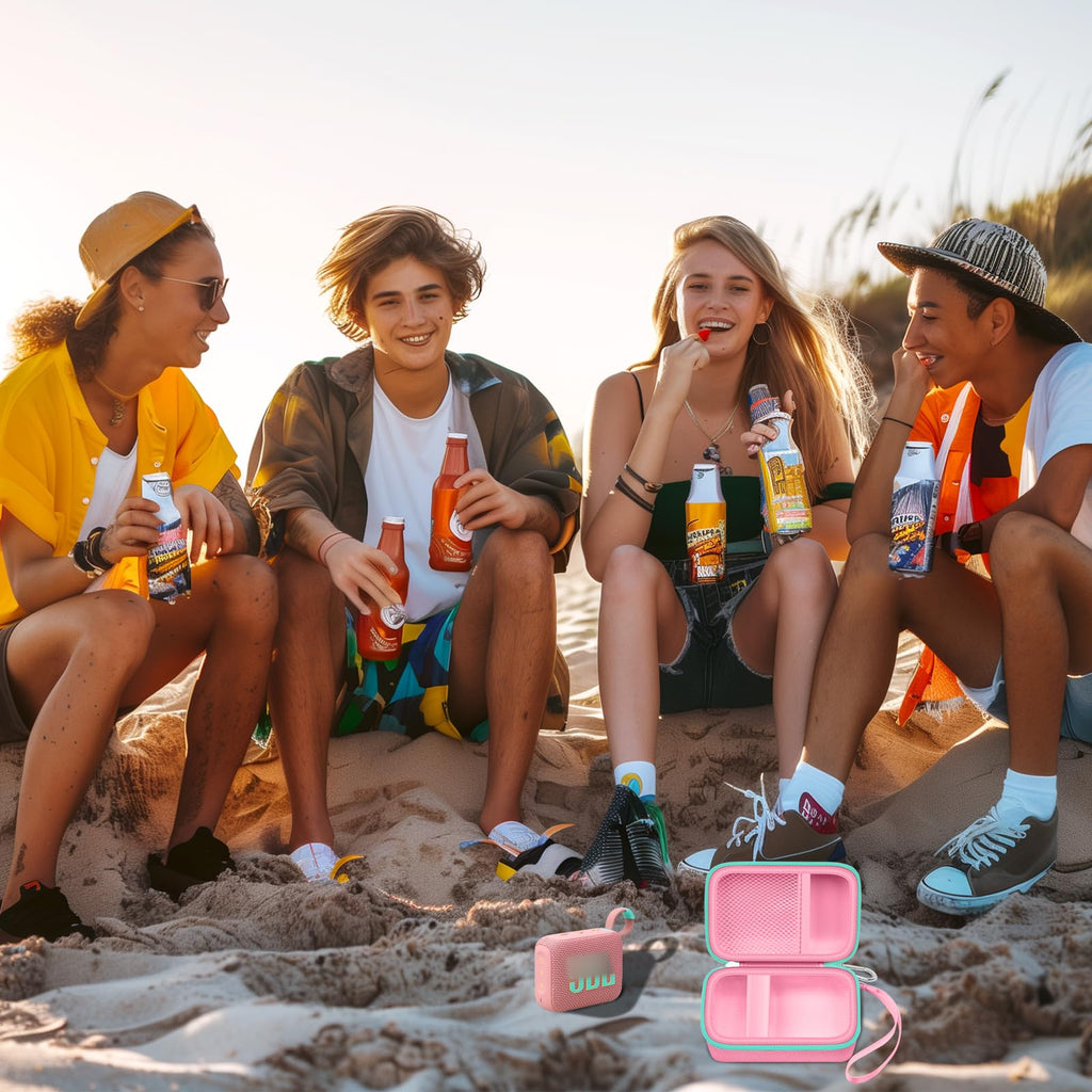 Friends using a for JBL Go speaker with the open pink and mint green travel case at the beach