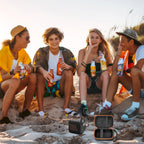 Friends using a for JBL Go speaker with the open black and orange travel case at the beach